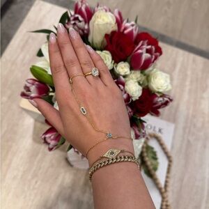 Gold plated hand chain bracelet with blue rhinestones